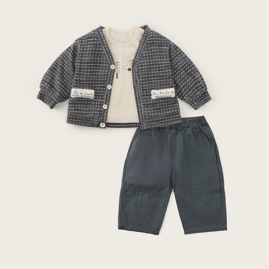 A toddler clothing set featuring a dark gray and white textured tweed cardigan with a cream inner lining, paired with dark gray pants, displayed on a light beige background with 'jacinda bebe' and 'lovely kids' text.