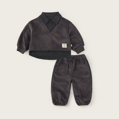 A baby clothing set from Jacinda Bebe, featuring a dark gray corduroy long-sleeve top with a striped shirt collar and matching corduroy pants, displayed on a light beige background with brand text.