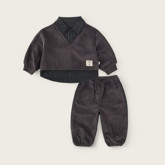 A baby clothing set from Jacinda Bebe, featuring a dark gray corduroy long-sleeve top with a striped shirt collar and matching corduroy pants, displayed on a light beige background with brand text.
