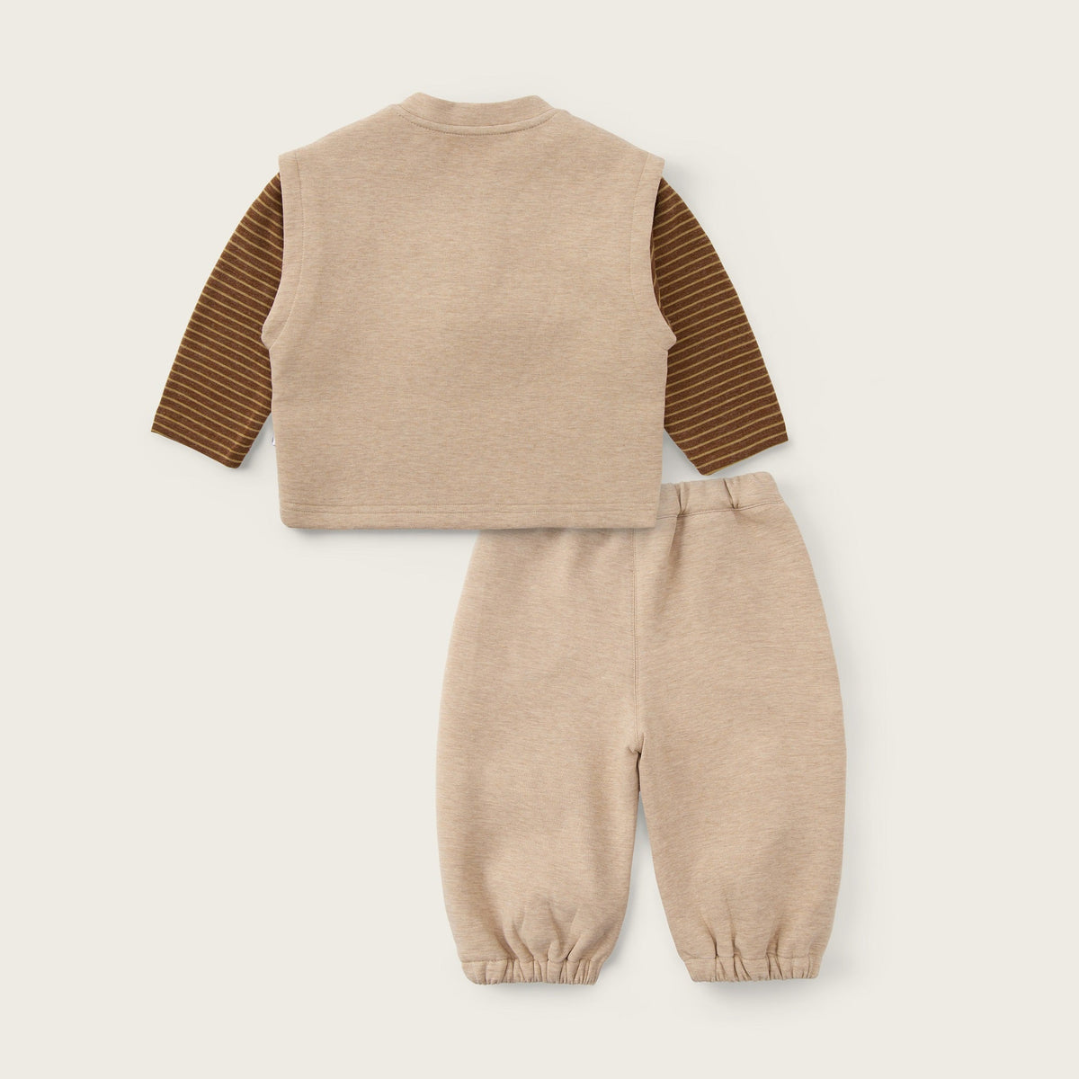 A baby clothing set featuring a beige knit vest with brown striped long sleeves and matching beige pants, displayed on a light beige background with 'jacinda bebe' and 'lovely kids' text.