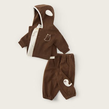 A two-piece baby outfit set in brown corduroy, featuring a hooded jacket with a white-trimmed hood and matching pants, displayed on a light beige background with decorative text.