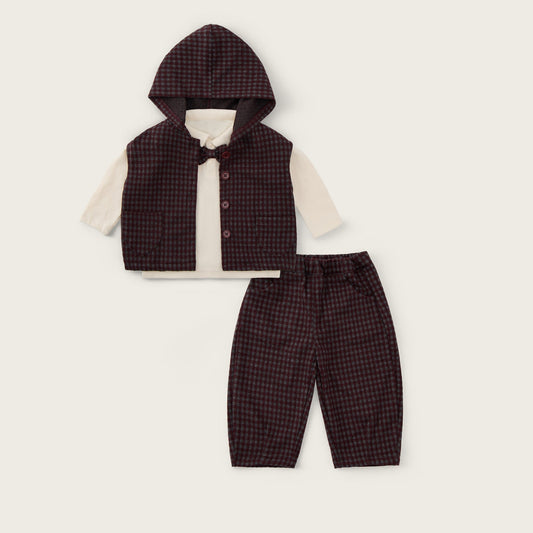 A baby boy's three-piece outfit set featuring a dark brown and black checkered hooded vest over a cream long-sleeve shirt, paired with matching checkered trousers. The brand names 'jacinda bebe' and 'lovely kids' are printed on the cream background.