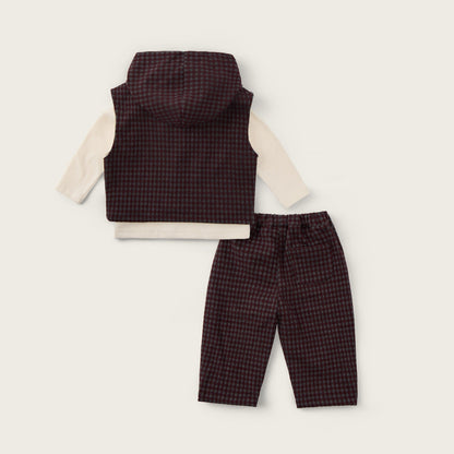 A baby clothing set from Jacinda Bebe, featuring a dark brown and red checkered vest over a cream long-sleeve shirt, paired with matching checkered pants, displayed on a light beige background with brand text.