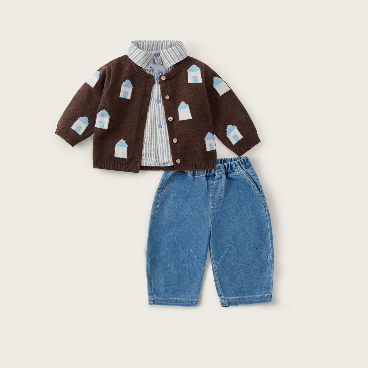 A baby clothing set featuring a brown cardigan with a white and blue house pattern, a striped shirt, and blue denim shorts, displayed on a light beige background with 'jacinda bebe' and 'lovely kids' text.