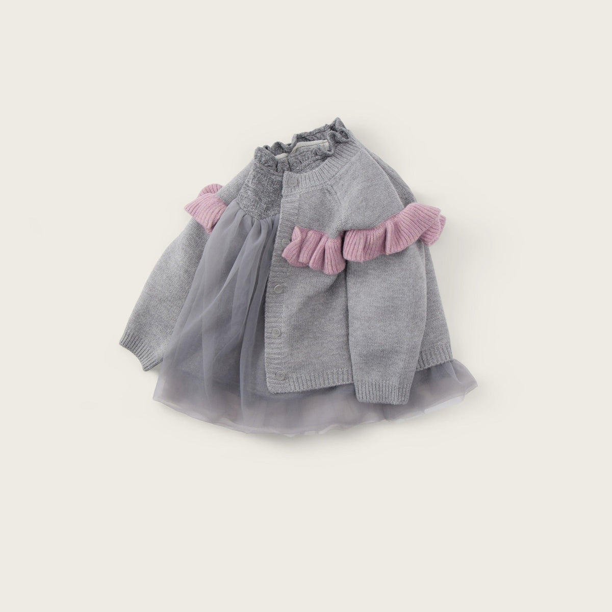 A baby girl's gray knit cardigan sweater with pink ruffle trim and a matching gray tulle skirt, displayed on a light beige background with 'jacinda bebe' at the top and 'lovely kids' at the bottom.