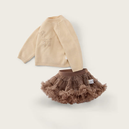 A baby girl's two-piece outfit set featuring a beige knit sweater with a small embroidered design and a brown ruffled tulle tutu skirt, displayed on a light cream background with 'jacinda bebe' and 'lovely kids' text.