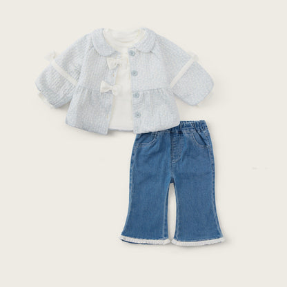 A baby girl's two-piece outfit set featuring a light blue textured knit cardigan with white trim and a white bow, paired with blue denim flare pants with white frayed hems. The set is displayed on a warm cream background with 'jacinda bebe' written at the top and 'lovely kids' at the bottom.