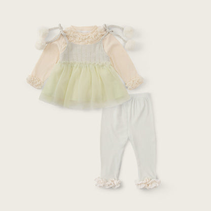 A baby girl's two-piece outfit set featuring a pale yellow tulle tutu dress with cream long sleeves and white pom-pom shoulder details, paired with white leggings with cream ruffle cuffs. The image is presented on a warm cream background with 'jacinda bebe' at the top and 'lovely kids' at the bottom.