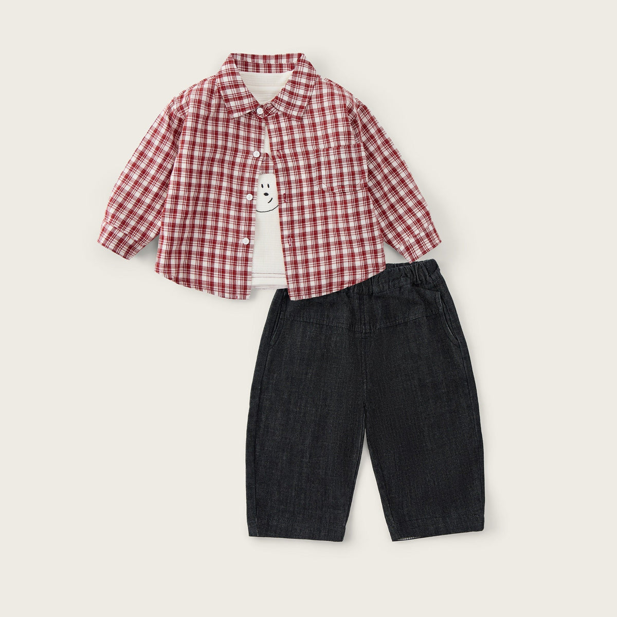 A children's outfit set featuring a red and white gingham long-sleeve shirt and dark navy denim shorts, displayed on a light beige background with 'jacinda bebe' at the top and 'lovely kids' at the bottom.